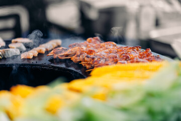 Cook grills kebab chicken open fire. Turns meat over with tongs. Concept Street food