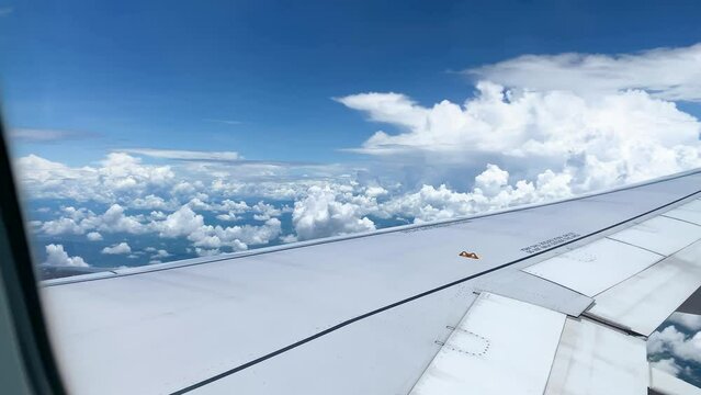 Above Bright blue sky and white clouds, view from window seat airplane, flight to holiday, travel, tour and journey world 