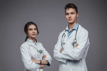 Photography of professional female and male doctors dresed in white labcoats.