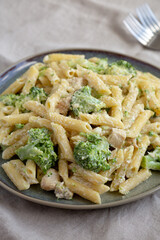 Homemade Penne Alfredo Pasta with Chicken and Broccoli on a Plate, side view.