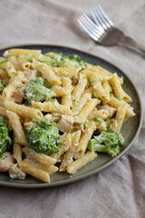 Homemade Penne Alfredo Pasta with Chicken and Broccoli on a Plate, low angle view.