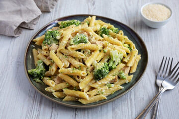 Homemade Penne Alfredo Pasta with Chicken and Broccoli on a Plate, side view.