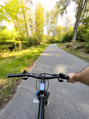 Fototapeta na wymiar Bike handlebar first person view. Concept of outdoor riding mountain bike.