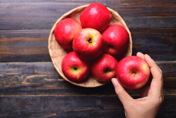 Red apple fruit holding by hand, Healthy eating, Top view