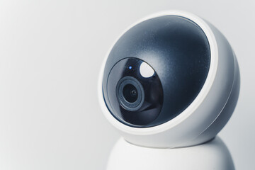 Close up modern surveillance IP camera on a white wall. Security system. High quality photo