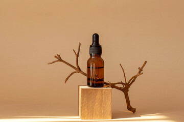 Serum in amber glass bottle with pipette on geometric wooden stand, 3d podium. Cosmetic...