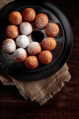 Balls of freshly baked homemade cottage cheese doughnuts.