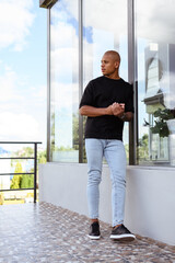 Young african american man looking away on balcony 