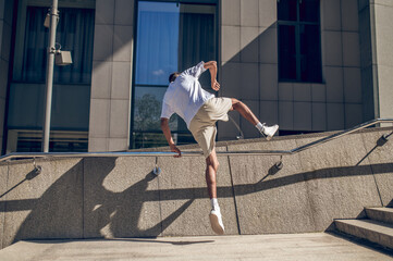 Young man in white tshirt jumping and looking energized