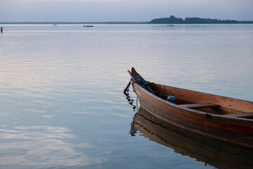 Boat on the shore of the lake. Beach by the lake