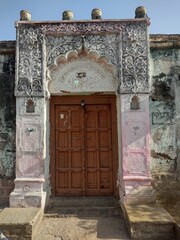 Indian village vintage old brown door closed with design structure