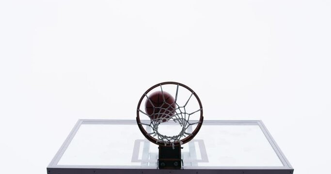 Basketball court, silhouette and man with basket jump trick at sports training practice mock up. Low angle of black male athlete doing slam dunk technique for net goal while playing a game.