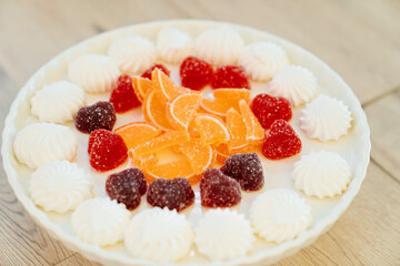 marshmallows and multicolored marmalade on a plate.