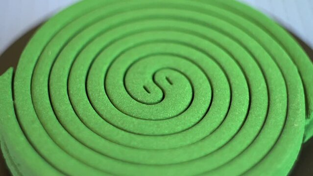 Mosquito repellent. Green spiral. Destruction of insects. Human protection. Comfort in the house. Rotation of an object. Close-up.