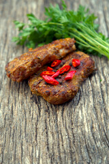 Meat steak cooked on the barbecue. Grilled fresh meat steak with spices and red pepper. Ready steak on the table with tomatoes and peppers. The concept of food, restaurants, traditional cuisine.
