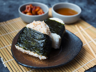 Onigiri Japanese traditional food, steamed rice in triangle shape wrap with seaweed.