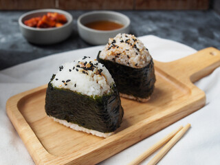 Onigiri Japanese traditional food, steamed rice in triangle shape wrap with seaweed.