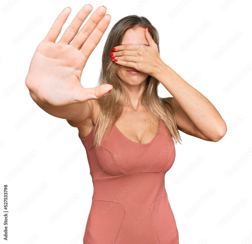 Poster beautiful caucasian woman wearing casual clothes covering eyes with hands and doing stop gesture wit