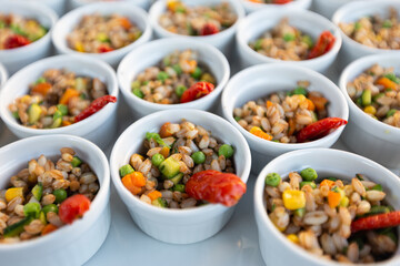 Finger food aperitif of spelled salad with zucchini and carrots. Aperitif banquet at the wedding party.