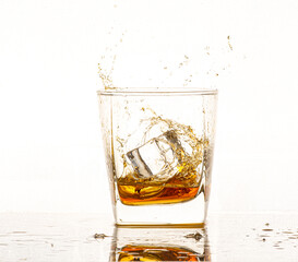 Isolated shot of whiskey with splash on black background