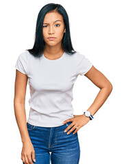Obraz premium Beautiful hispanic woman wearing casual white tshirt skeptic and nervous, frowning upset because of problem. negative person.