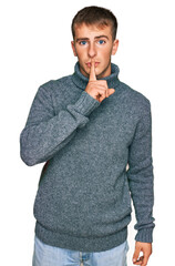 Young blond man wearing casual clothes asking to be quiet with finger on lips. silence and secret concept.
