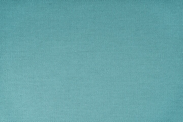 Texture of natural turquoise fabric or cloth. Fabric texture diagonal weave of natural cotton or linen textile material. Blue canvas background. Decorative fabric for curtain, furniture, walls, cloth