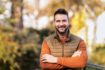 Smiling man standing outside in autumn weather