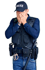 Young handsome man wearing police uniform with sad expression covering face with hands while crying. depression concept.