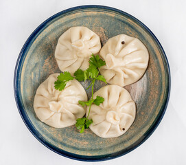 Large khinkali with lamb on a plate top view