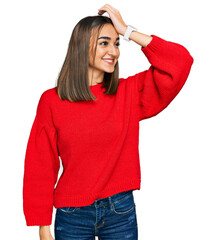 Beautiful brunette woman wearing casual winter sweater smiling confident touching hair with hand up gesture, posing attractive and fashionable