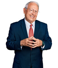 Senior man with grey hair wearing business suit and glasses hands together and fingers crossed...