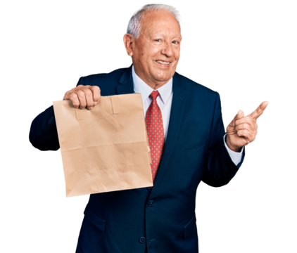 Senior business man with grey hair holding take away paper bag smiling happy pointing with hand and finger to the side