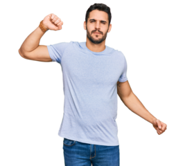 Young hispanic man wearing casual clothes stretching back, tired and relaxed, sleepy and yawning for early morning