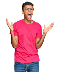 Young handsome african american man wearing casual clothes crazy and mad shouting and yelling with aggressive expression and arms raised. frustration concept.