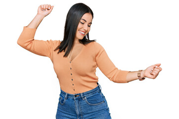 Young hispanic woman wearing casual clothes dancing happy and cheerful, smiling moving casual and confident listening to music