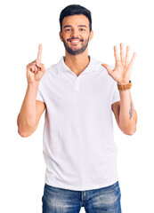 Naklejka premium Young handsome hispanic man wearing casual clothes showing and pointing up with fingers number six while smiling confident and happy.