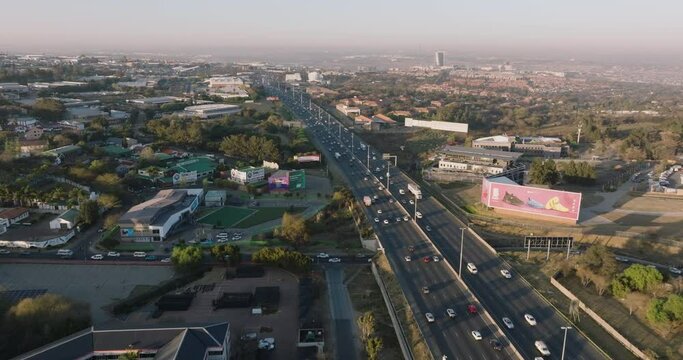 Scenic aerial view of Johannesburg N1 highway traffic. Johannesburg skyline in the background surrounded by smog and pollution