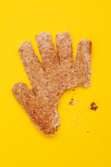 Toast hand shape with bite mark and crumbs