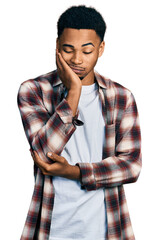 Young african american man wearing casual clothes thinking looking tired and bored with depression problems with crossed arms.