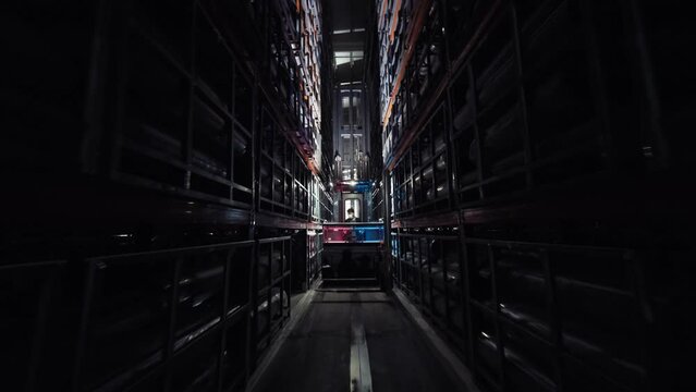 industrial warehouse. Camera moving between pallets with goods and materials ordered in warehouse. Forklift moving in large warehouse logistics terminal . 4k
