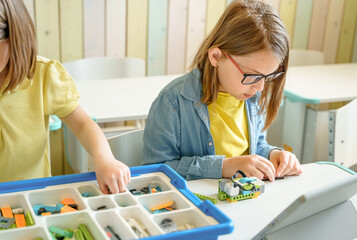 Programming work, learning robotics in elementary school. Children students assembly, launch,...