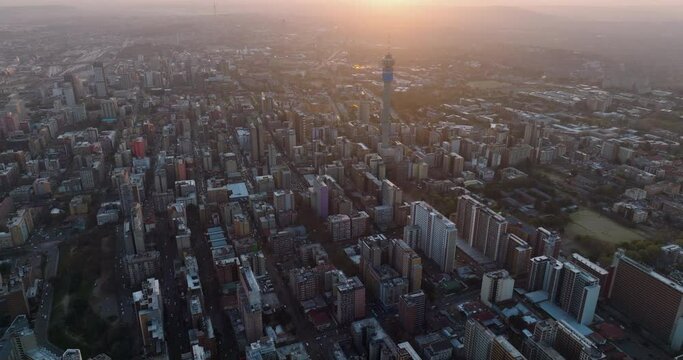 High aerial view of the magnificent Johannesburg City Centre at sunset surrounded by smog and pollution.