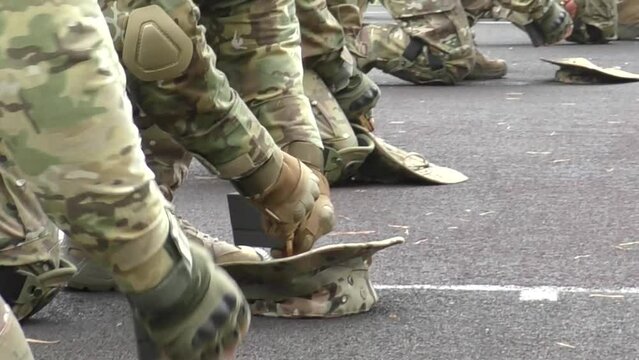 Poltava-Kharkiv region, Ukraine - August 2022: Ukrainian military man receives cartridges for a machine gun. A soldier of a volunteer formation of a territorial community inserts cartridges