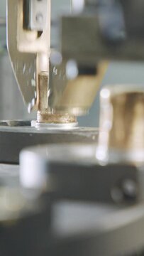Vertical video of Advanced robotic machine manufacturing parts in an automated assembly line