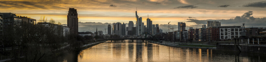 Fototapeta na wymiar Frankfurt skyline at sunset panorama wide view from bridge over main river