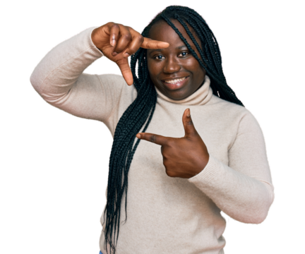 Young black woman with braids wearing casual winter sweater smiling making frame with hands and fingers with happy face. creativity and photography concept.