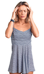 Beautiful caucasian woman wearing summer dress with hand on head for pain in head because stress. suffering migraine.