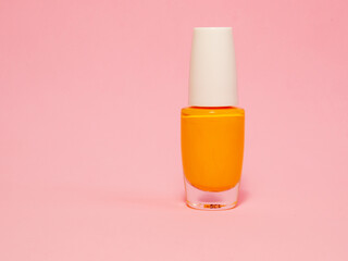 yellow nail polish with a pink background