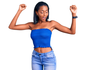 Young african american woman wearing casual summer clothes dancing happy and cheerful, smiling moving casual and confident listening to music
